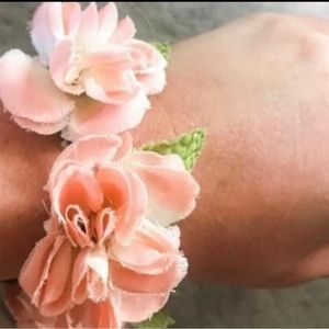 Pink flower ponytail can be worn around wrist or in hair.